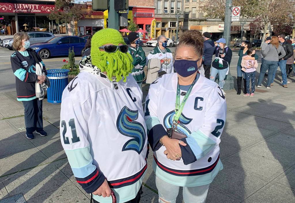 Jeremy Greenia and his sister Nikki Webb are dressed for the occasion outside Angel of the Winds Arena in Everett, where the Seattle Kraken will play the Edmonton Oilers on Friday. (Jake Goldstein-Street / The Herald)