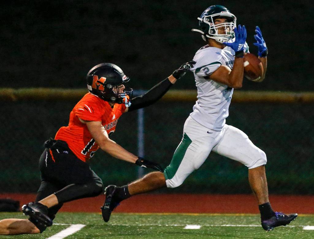 Edmonds-Woodways Jacob Sanchez-Arias attempts to haul in the pass the Monroes Eli Miller defending Friday night at Monroe High School on October 1, 2021. (Kevin Clark / The Herald)