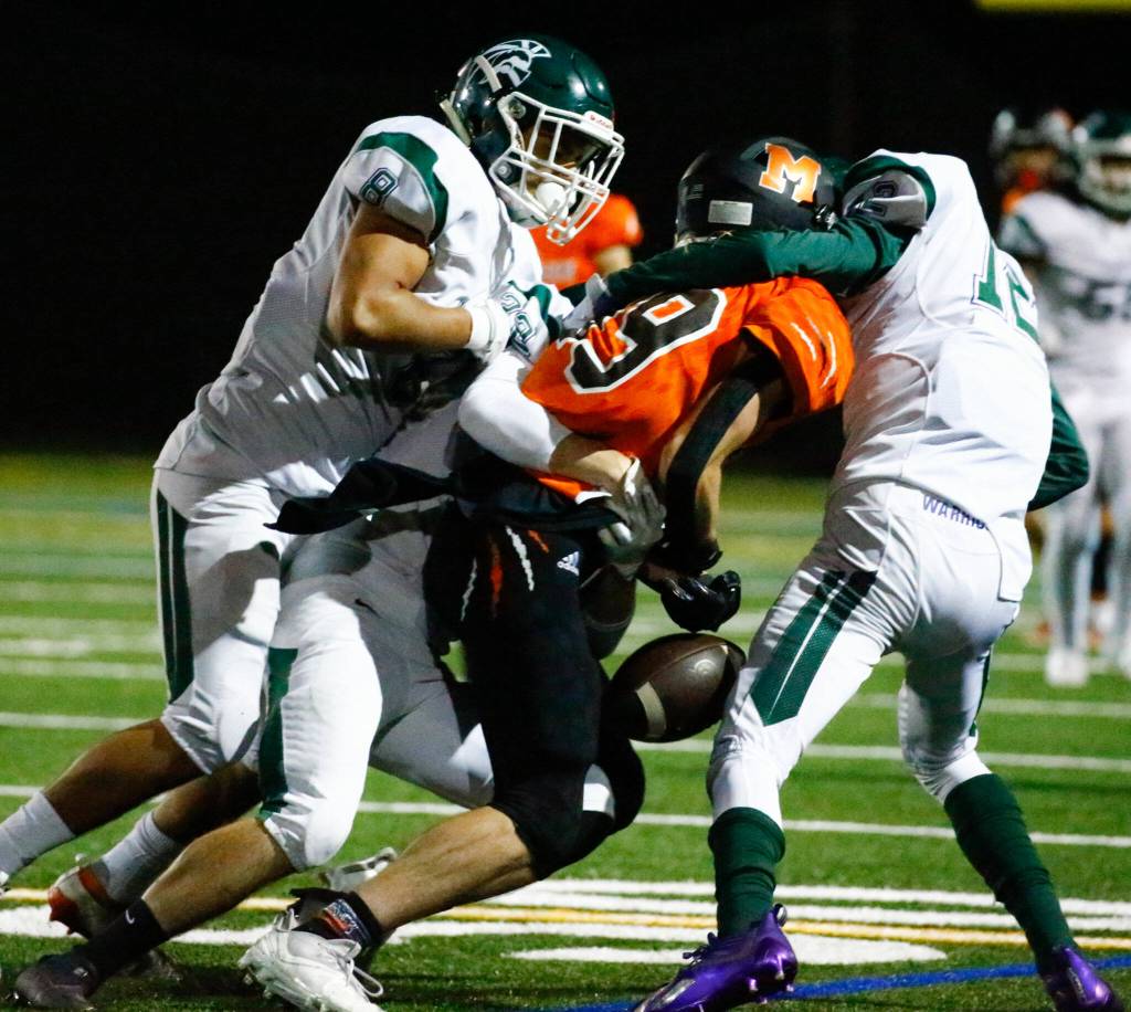 Edmonds-Woodways defense forces a fumble Monroes Liam OBrian Friday night at Monroe High School on October 1, 2021. (Kevin Clark / The Herald)
