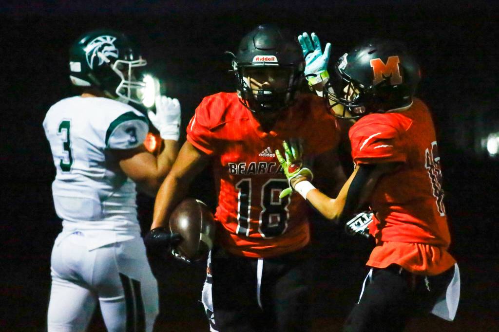 Monroes Matthew Rodriquez, right, celebrates Monroes Cole Pruetts (18) touchdown Friday night at Monroe High School on October 1, 2021. (Kevin Clark / The Herald)