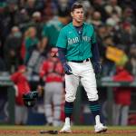 Seattle Mariners' Dylan Moore drops his batting helmet as he reacts after being called out on strikes to end the seventh inning of a baseball game against the Los Angeles Angels with two men on base, Friday, Oct. 1, 2021, in Seattle. (AP Photo/Ted S. Warren)
