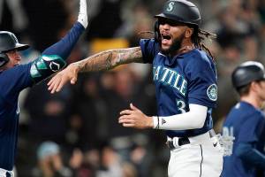 Seattle Mariners' J.P. Crawford celebrates after scoring against the Los Angeles Angels in the eighth inning of a baseball game Saturday, Oct. 2, 2021, in Seattle. (AP Photo/Elaine Thompson)