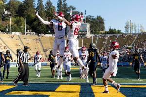 Washington State wide receiver De'Zhaun Stribling, right, celebrates with wide receiver Donovan Ollie (6) after scoring a touchdown against California in the third quarter of an NCAA college football game in Berkeley, Calif., Saturday, Oct. 2, 2021. Washington State won 21-6. (AP Photo/John Hefti)
