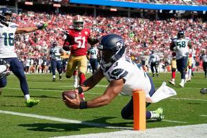 Seattle Seahawks quarterback Russell Wilson (3) runs for a touchdown against the San Francisco 49ers during the second half of an NFL football game in Santa Clara, Calif., Sunday, Oct. 3, 2021. (AP Photo/Tony Avelar)