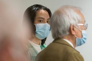Duy Phuong Nguyen, 28, of Everett, listens to his interpreter (right) during a plea hearing at the Snohomish County Courthouse on Tuesday, Oct. 5, 2021 in Everett, Washington. Nguyen pleaded guilty to first-degree murder for the killing of Thanh Vy Ly, 20, and to two counts of first-degree assault for shooting Ly’s boyfriend and his own wife in 2020. (Andy Bronson / The Herald)