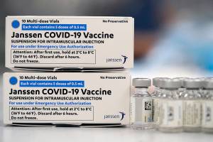 FILE - Boxes containing the Johnson & Johnson COVID-19 vaccine sit next to vials in the pharmacy of National Jewish Hospital for distribution, in east Denver. A judge on Wednesday, Sept. 29, 2021, dismissed an attempt by a group of Denver police officers to block the city's vaccine mandate from taking effect. (AP Photo/David Zalubowski,File)