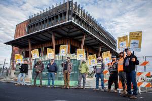 A handful of Northwest Union Carpenter members picket in front of the new Marysville civic center construction site on the sixth day of a region wide union carpenter strike on Wednesday, Sept. 22, 2021 in Marysville, Wa. (Olivia Vanni / The Herald)