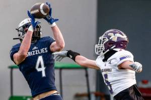 Glacier Peaks Cooper Jensen makes a touchdown reception against Lake Stevens Alexander Davis Thursday night at Veterans Memorial Stadium in Snohomish on April 1, 2021. (Kevin Clark / The Herald)