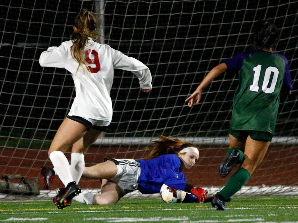 Snohomishs goal keeper Taylor Graham stops a shot at goal Thursday night at Edmonds-Woodway High School in Edmonds on October 7, 2021. (Kevin Clark / The Herald)