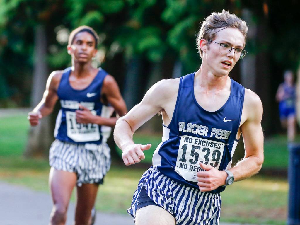 Glacier Peaks Levi Nichols, left, and Nicholas LeBar compete in a meet Wednesday afternoon at Hamlin Park in Seattle on October 6, 2021. (Kevin Clark / The Herald)