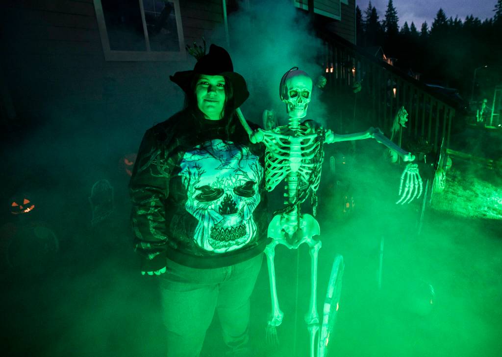Brandi Smith of Arlington once again curated a Halloween map for Snohomish County. Here, she shows off the Halloween display in her front yard, complete with fog machine. (Olivia Vanni / The Herald)