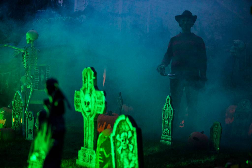 Michael Smith, dressed as Freddy Krueger, wanders through a Halloween scene Saturday in Arlington. (Olivia Vanni / The Herald)