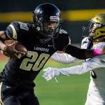 Lynnwoods Jordan Whittle (left) fends off a tackle attempt during a game against Everett on Frida in Edmonds. (Olivia Vanni / The Herald)