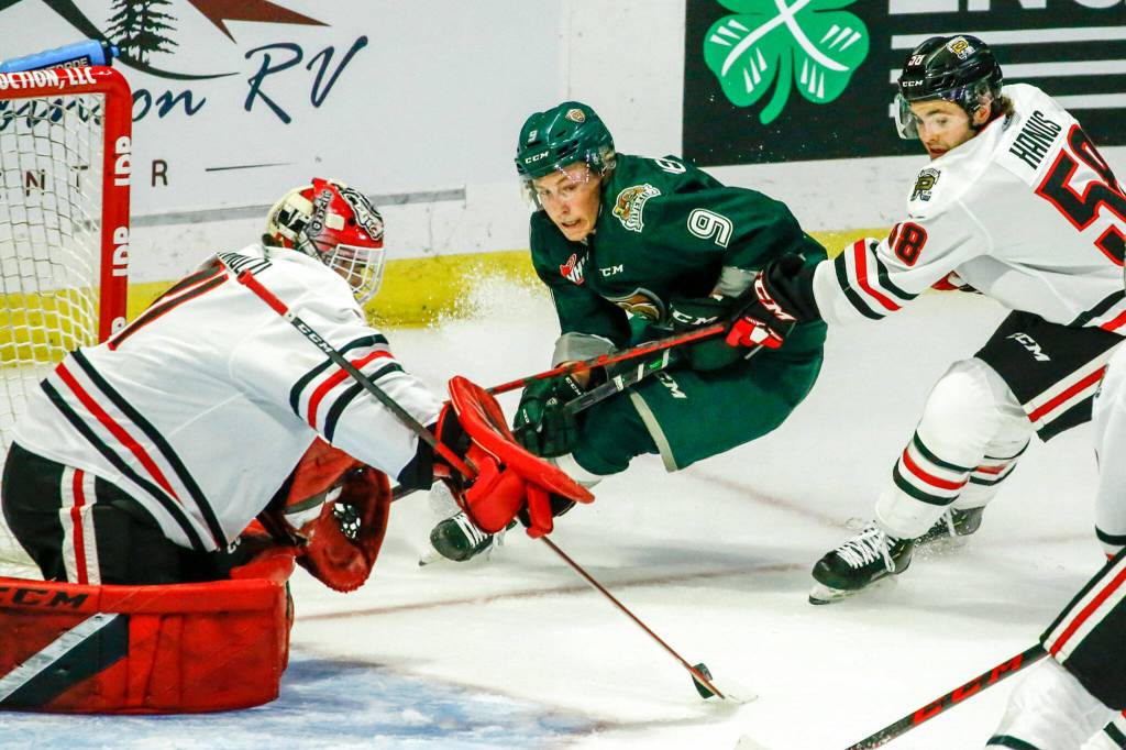 Everetts Ben Hemmerling shoots with Portlands Dante Giannuzzi defending and Portlands Clay Hanus trailing Friday night at the Angel of the Winds Arena in Everett on October 8, 2021. (Kevin Clark / The Herald)