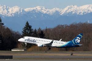 With the Olympic mountains in the background, the first passenger flight by Alaska Airlines Flight 2878 departs for Portland on opening day of the Paine Field Terminal on Monday, March 4, 2019 in Everett, Wash. (Andy Bronson / The Herald)