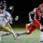 Marysville-Pilchuck's Dylan Carson breaks through the Arlington defense to run the ball in for a touchdown during the game on Friday, March 19, 2021 in Marysville, Wa. (Olivia Vanni / The Herald)