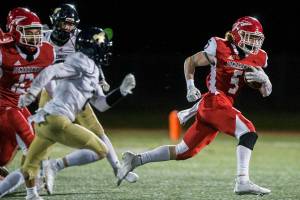 Marysville-Pilchuck's Dylan Carson breaks through the Arlington defense to run the ball in for a touchdown during the game on Friday, March 19, 2021 in Marysville, Wa. (Olivia Vanni / The Herald)