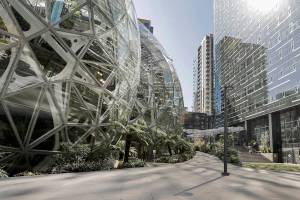 FILE - In this March 20, 2020, file photo, the Amazon campus outside the company headquarters in Seattle sits nearly deserted on an otherwise sunny and warm afternoon. Amazon said Monday, Oct. 11, 2021 it will allow many tech and corporate workers to continue working remotely indefinitely, as long as they can commute to the office when necessary. (AP Photo/Elaine Thompson, File)