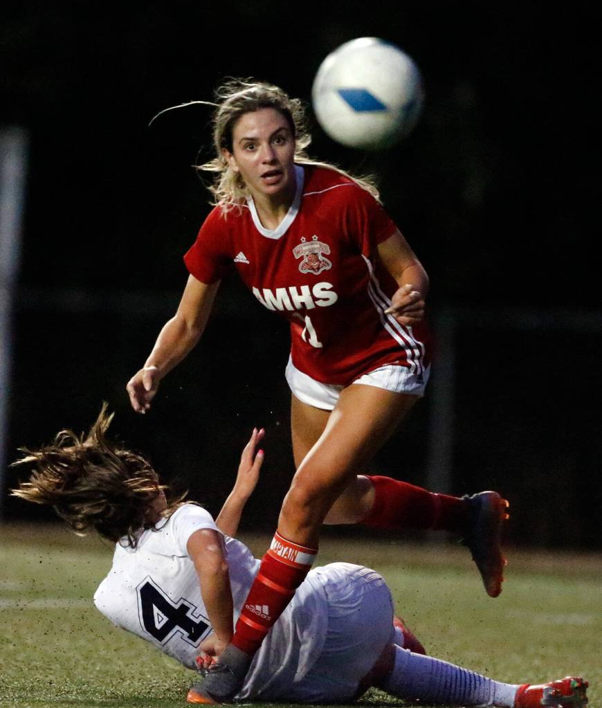 Archbishop Murphys Taylor Campbell (top) and Arlingtons Maddy Stivers battle for control of the ball during a game on Sept. 14, 2021, at Archbishop Murphy High School in Everett. The Wildcats won 6-1. (Kevin Clark / The Herald)