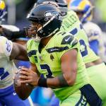 Seattle Seahawks quarterback Russell Wilson looks to pass against the Los Angeles Rams during the first half of an NFL football game, Thursday, Oct. 7, 2021, in Seattle. (AP Photo/Elaine Thompson)