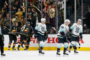 Seattle Kraken defensemen Jeremy Lauzon (55) and Vince Dunn (29) and center Ryan Donato skate off the ice after the Vegas Golden Knights scored a goal during the first period of an NHL hockey game Tuesday, Oct. 12, 2021, in Las Vegas. (AP Photo/Chase Stevens)