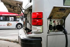 Buses charge before their next route Friday afternoon at the Everett Transit Center in Everett on October 22, 2021.  (Kevin Clark / The Herald)