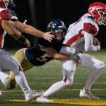 Arlington defensive lineman Josh Snow sacks Marysville Pilchuck quarterback Jace Luton. (Olivia Vanni / The Herald)