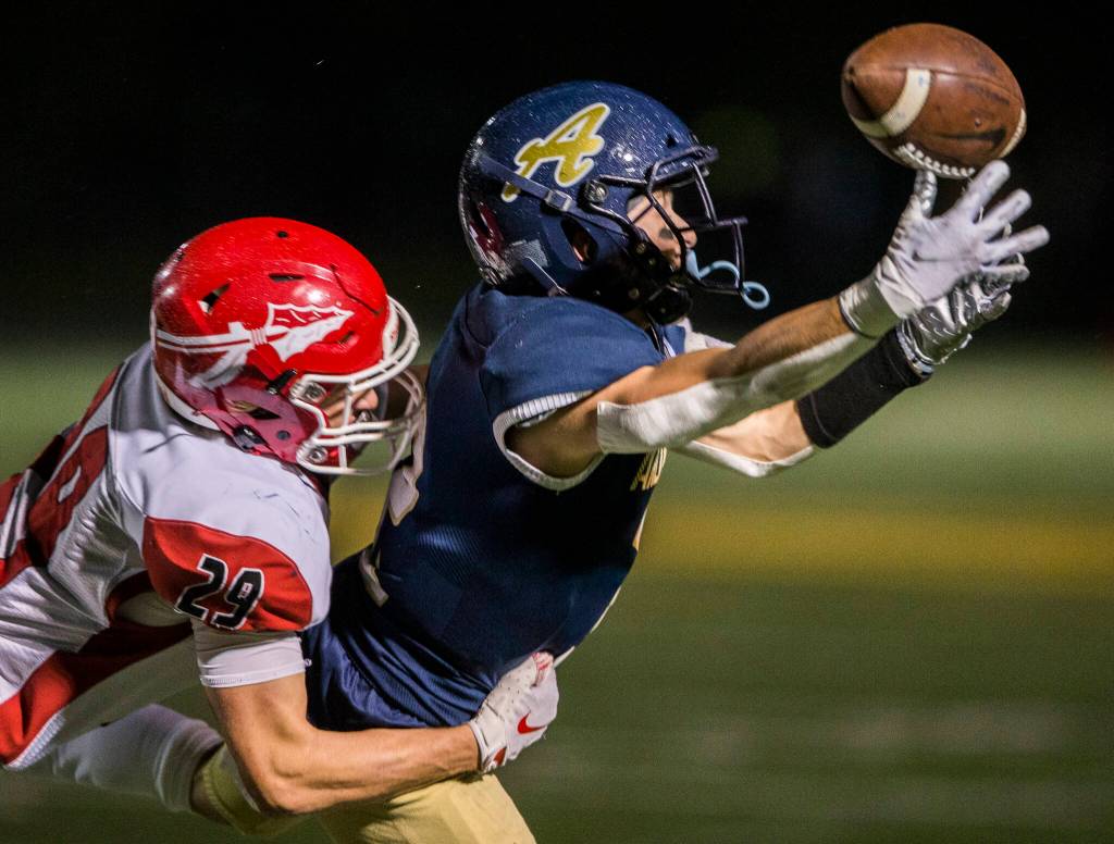 Arlingtons Levi Younger reaches out for a pass Friday during the game against Marysville-Pilchuck in Arlington. (Olivia Vanni / The Herald)
