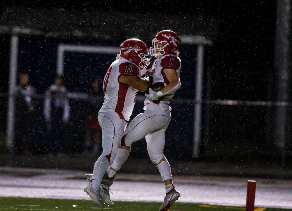 Marysville-Pilchucks Dylan Carson celebrates his touchdown with Jace Luton during the game Friday against Arlington in Arlington. (Olivia Vanni / The Herald)