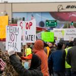 People hold signs in protest of the vaccine mandate Friday in Everett, after Boeing announced it would terminate workers who do not comply. (Olivia Vanni / The Herald)