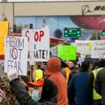 People hold signs in protest of the vaccine mandate after Boeing announced it would terminate workers who do not comply on Friday, Oct. 15, 2021 in Everett, Wa. (Olivia Vanni / The Herald)