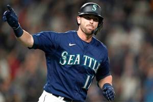 Seattle Mariners' Mitch Haniger motions toward his dugout as he begins to round the bases on his two-run home run against the Los Angeles Angels in the fifth inning of a baseball game Saturday, Oct. 2, 2021, in Seattle. (AP Photo/Elaine Thompson)