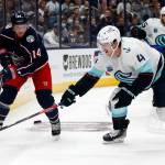 Blue Jackets forward Gustav Nyquist (left) passes in front of Kraken defenseman Haydn Fleury during the second period of a game Saturday in Columbus, Ohio. (AP Photo/Paul Vernon)