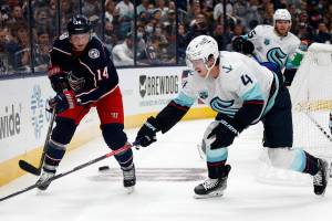Columbus Blue Jackets forward Gustav Nyquist, left, passes in front of Seattle Kraken defenseman Haydn Fleury during the second period of an NHL hockey game in Columbus, Ohio, Saturday, Oct. 16, 2021. (AP Photo/Paul Vernon)