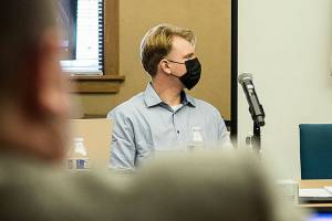 Alejandro Meza watches a video of the altercation he had with Gene Peterson on Community Transit bus during opening statements of his trial on Wednesday, Oct. 20, 2021 in Everett, Wa. (Olivia Vanni / The Herald)