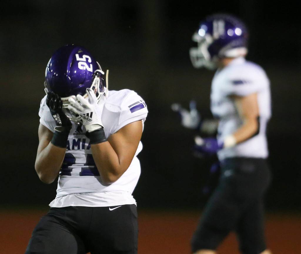 Kamiaks Jullian Notoa covers his face after fumbling the ball through the end zone for a touchback as Kamiak beat Mariner 41-14 in a football game at Goddard Stadium on Tuesday, Oct. 19, 2021 in Everett, Washington. (Andy Bronson / The Herald)
