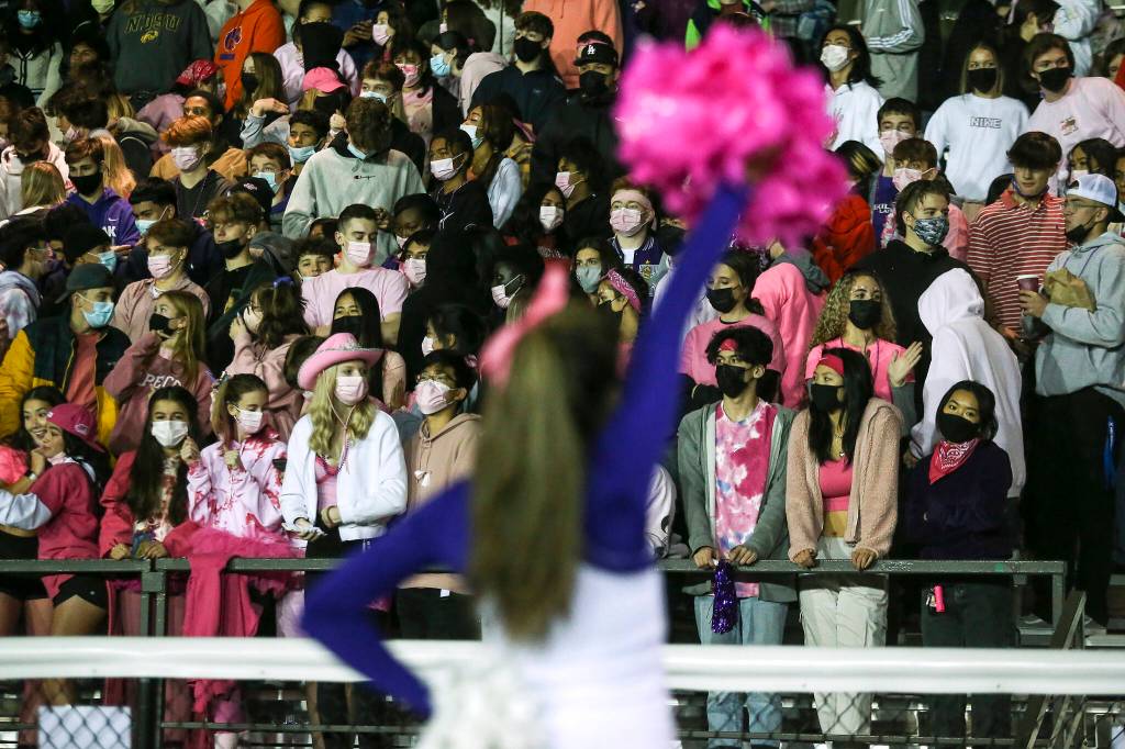 Kamiak fans mask up for the game. Kamiak beat Mariner 41-14 in a football game at Goddard Stadium on Tuesday, Oct. 19, 2021 in Everett, Washington. (Andy Bronson / The Herald)