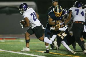 Kamiak's Jullian Notoa runs in for a touchdown as Kamiak led Mariner 28-7 at the half in a football game at Goddard Stadium on Tuesday, Oct. 19, 2021 in Everett, Washington.  (Andy Bronson / The Herald)