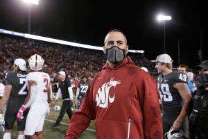 Washington State coach Nick Rolovich walks on the field after the team's NCAA college football game against Stanford, Saturday, Oct. 16, 2021, in Pullman, Wash. Washington State won 34-31. (AP Photo/Young Kwak)