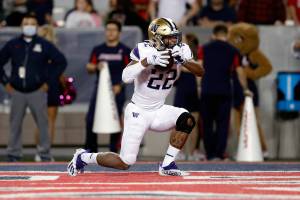 Washington running back Cameron Davis (22) reacts after scoring a touchdown during the second half of the team's NCAA college football game against Arizona on Friday, Oct. 22, 2021, in Tucson, Ariz. (AP Photo/Chris Coduto)