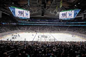 The Seattle Kraken and the Vancouver Canucks play during the first period of an NHL hockey game Saturday, Oct. 23, 2021, in Seattle, in the expansion team's home-opener. (AP Photo/Elaine Thompson)