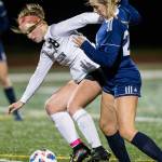 Jacksons Lindyn Solis and Glacier Peaks Ryann Reynolds fight for the ball during the game Tuesday in Snohomish. (Olivia Vanni / The Herald)