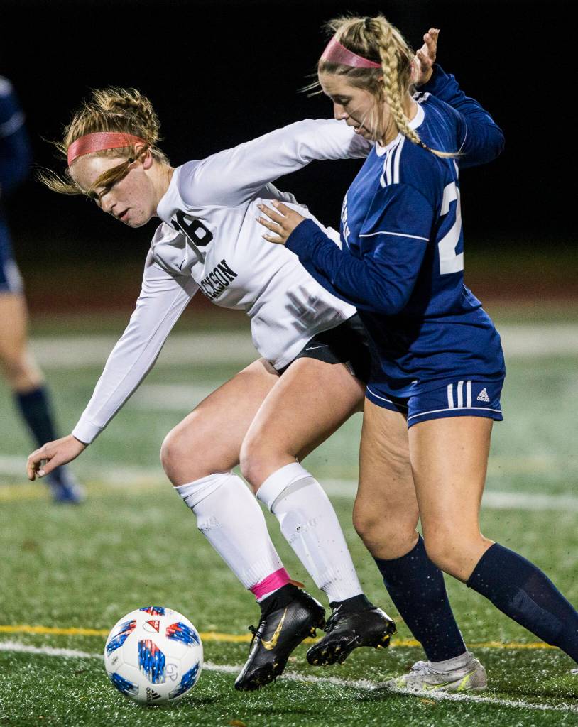 Jacksons Lindyn Solis and Glacier Peaks Ryann Reynolds fight for the ball during the game Tuesday in Snohomish. (Olivia Vanni / The Herald)