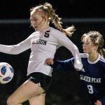 Jackson's Avery Friedricksen jumps to trap the ball during the game against Glacier Peak on Tuesday, Oct. 26, 2021 in Snohomish, Wa. (Olivia Vanni / The Herald)