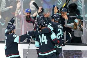 Seattle Kraken players celebrate after Haydn Fleury scored against the Minnesota Wild during the second period of an NHL hockey game, Thursday, Oct. 28, 2021, in Seattle. (AP Photo/Ted S. Warren)