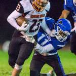 Granite Falls Gio Gonzalez grabs the face mask of South Whidbeys Prince Browne as he tries to escape a tackle during the game on Friday, Oct. 29, 2021 in Langley, Wa. (Olivia Vanni / The Herald)