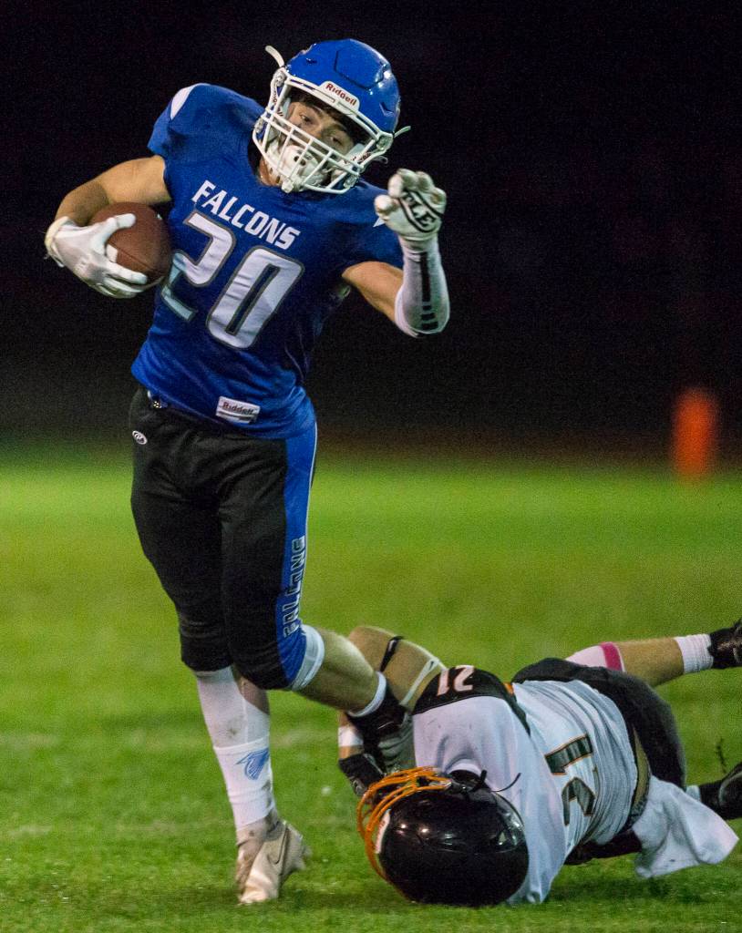 South Whidbeys Erik Haugen escapes a tackle by Granite Falls Bradley Kehoe during the game on Friday, Oct. 29, 2021 in Langley, Wa. (Olivia Vanni / The Herald)