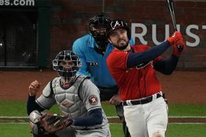 Atlanta Braves' Travis d'Arnaud watches his home run during the eighth inning in Game 3 of baseball's World Series between the Houston Astros and the Atlanta Braves Friday, Oct. 29, 2021, in Atlanta. (AP Photo/John Bazemore)