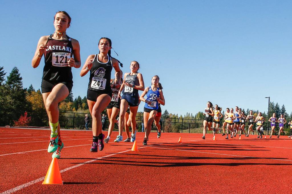 Kamiaks Emma Arceo, second in image, finishes 12th Saturday afternoon during the 4A District 1 Cross Country Championships at Lakewood High School in Arlington on October 30, 2021. (Kevin Clark / The Herald)