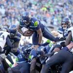 Seattle Seahawks quarterback Geno Smith leaps up and over the line of scrimmage to score a touchdown against the Jacksonville Jaguars during the first half of an NFL football game, Sunday, Oct. 31, 2021, in Seattle. (AP Photo/Stephen Brashear)